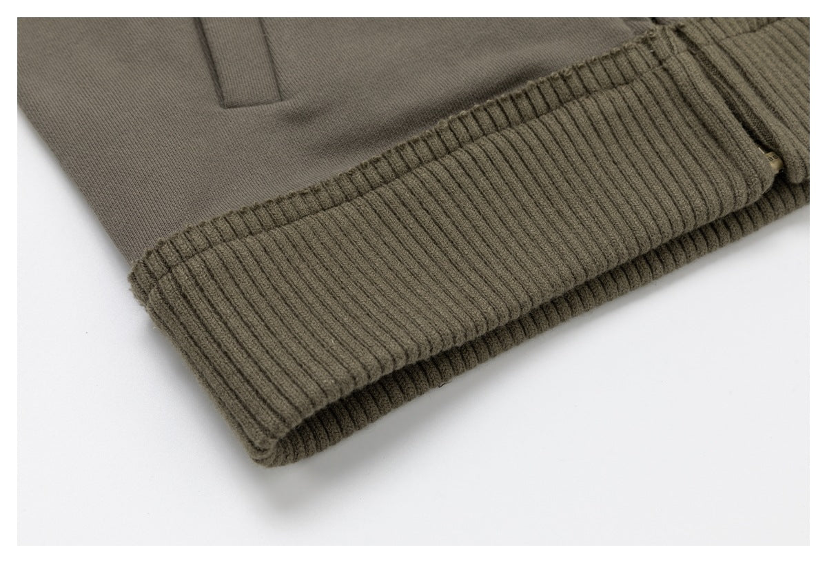 Close-up of the jacket’s wide ribbed hem and smooth taupe body fabric.