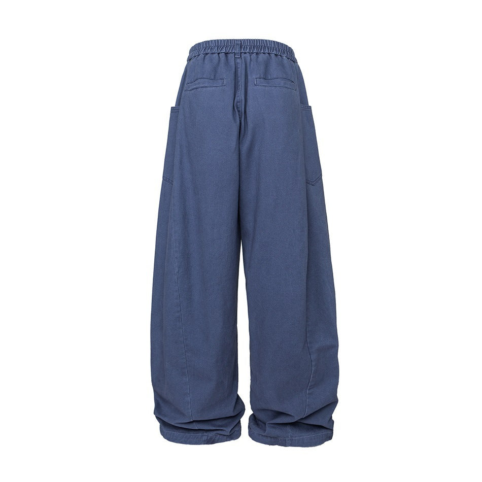 Back view of blue wide-leg pants with an elastic waist, two rear welt pockets, and large side pockets.