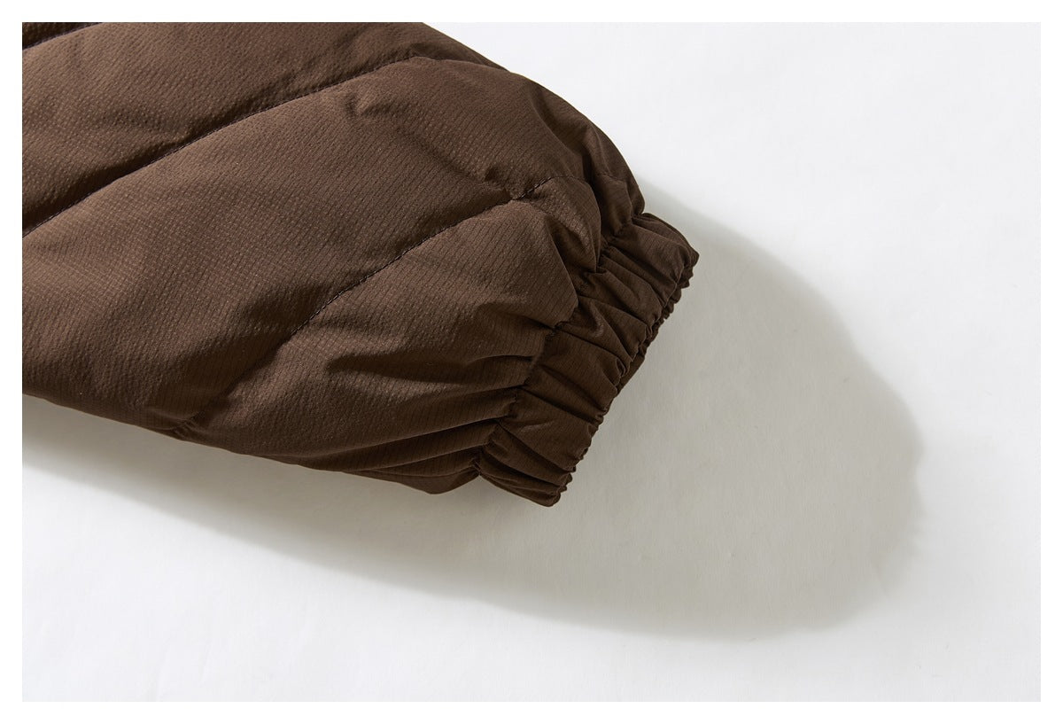 Close-up of a brown jacket sleeve ending in a gathered elastic cuff.