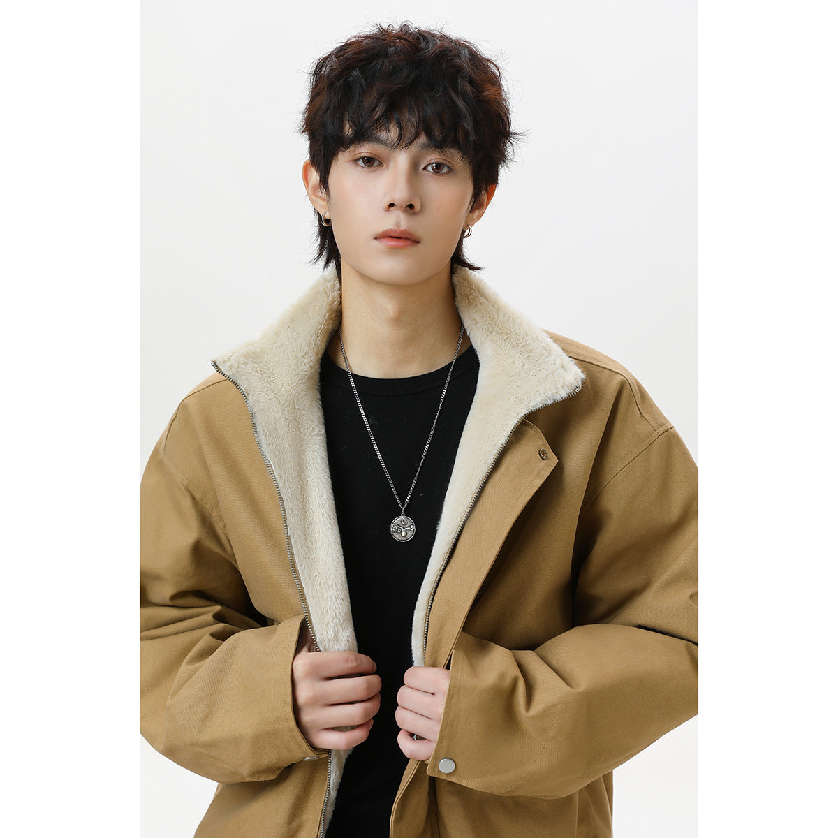 Model wearing a tan zip-front jacket with a cream fleece lining and high collar.