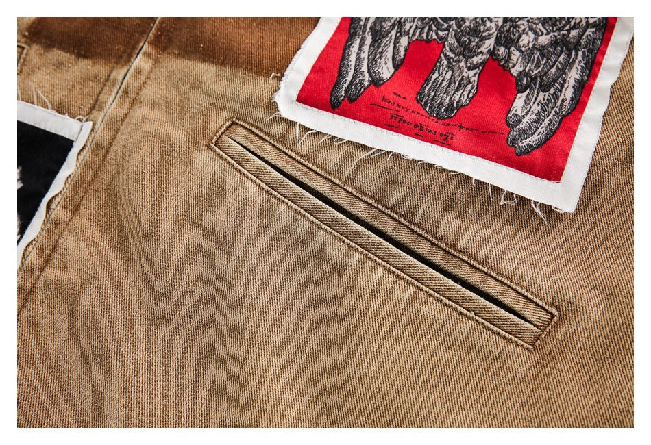 Close-up of a tan jacket's narrow welt pocket beside the edge of a red owl patch.