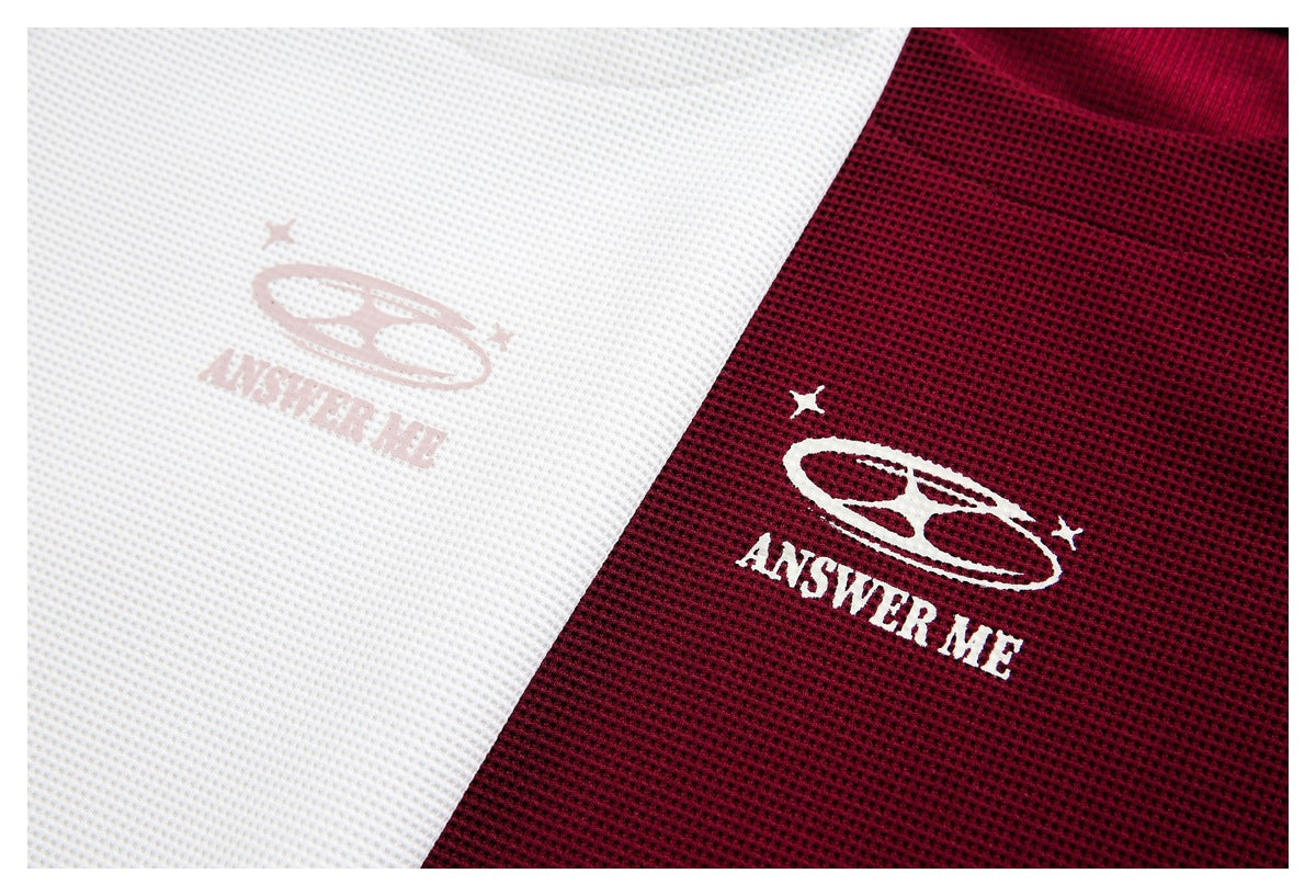 Close-up of white and burgundy textured shirts with matching star-and-oval artwork and “ANSWER ME” lettering.