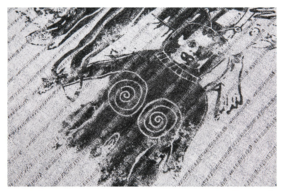 Close-up of a black graphic with spiral details on light gray open-knit fabric.