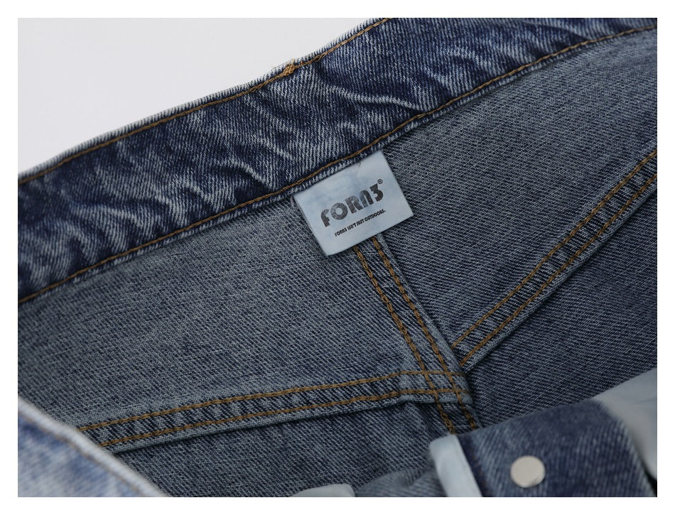 Inside view of the jeans' waistband and seams, with a small brand label attached.