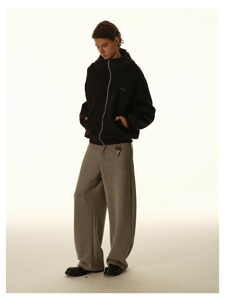 Full-length model wearing a black zip-up hoodie, wide-leg gray pants and black shoes.