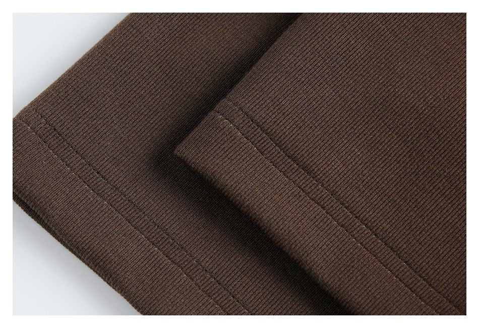 Close-up of brown rib-knit fabric with parallel stitching along a folded edge.