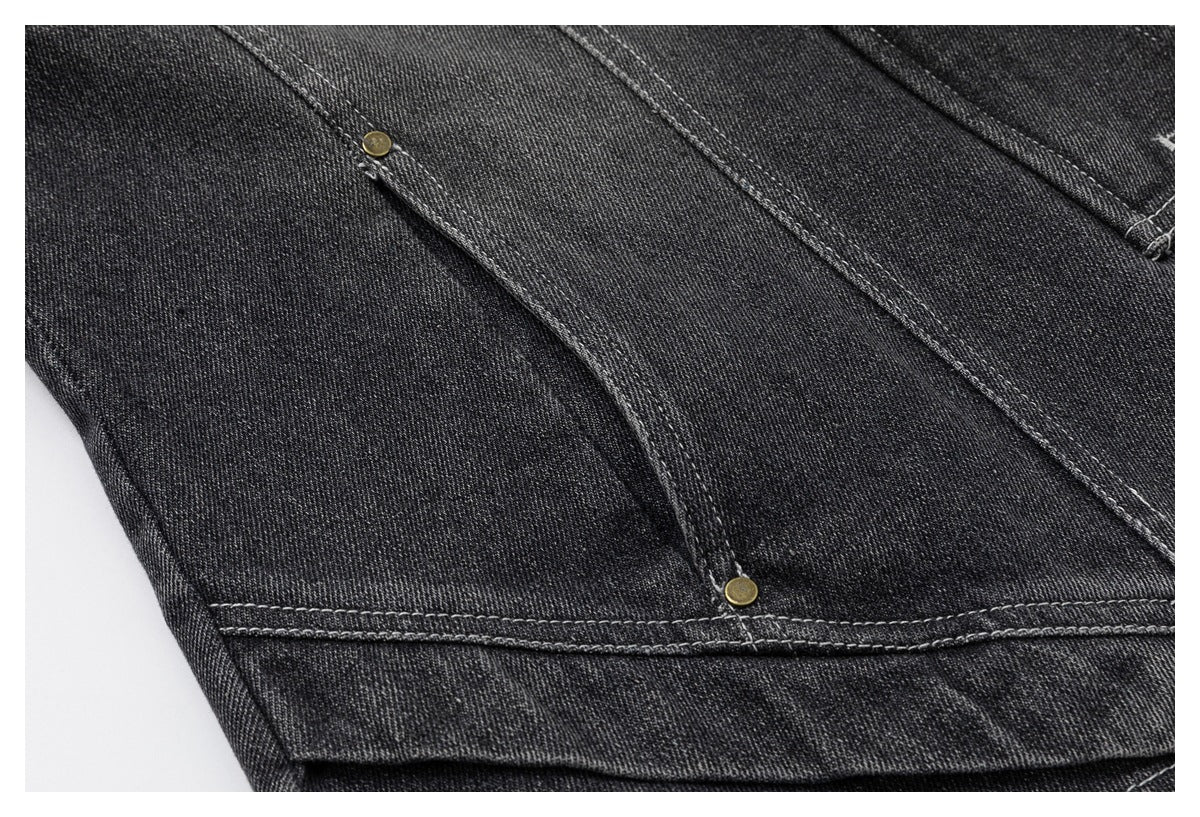 Close-up of the jacket's curved stitched panel and lower hem with small brass-tone rivets.