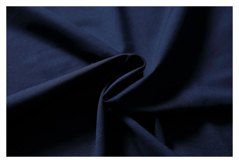 Close-up of dark navy fabric gathered into a fold.