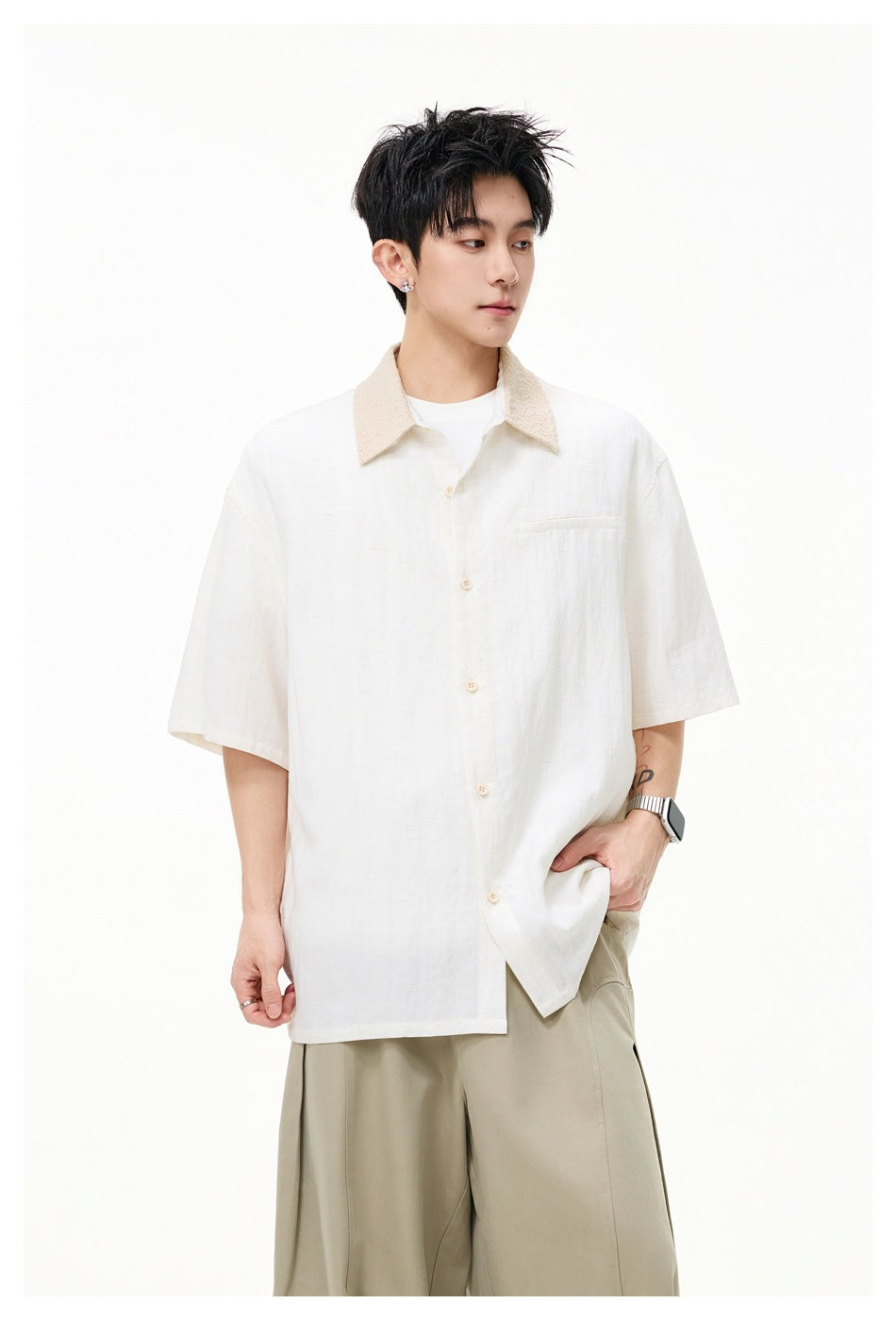 Model wearing an ivory short-sleeve button-up shirt with a beige textured collar and chest pocket, paired with khaki