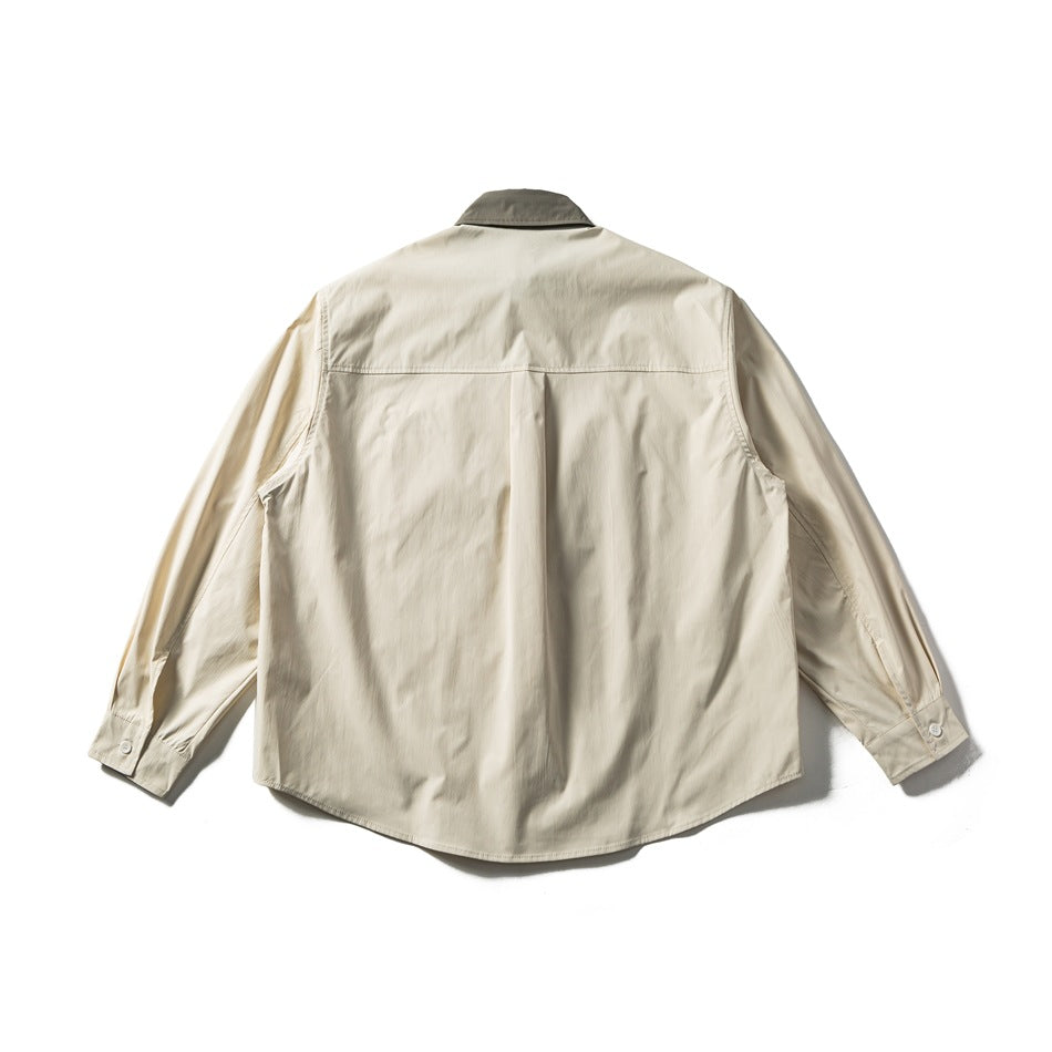 Back view of an ivory long-sleeve button-up shirt with a gray collar, back yoke, and curved hem.