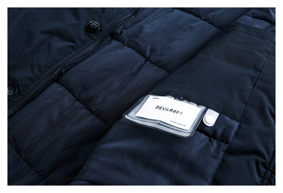 Close-up of a dark navy quilted jacket interior with a sewn-in DEVILRAY label.
