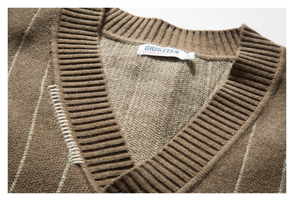 Close-up of a brown striped cardigan's ribbed V-neck, knit texture, and sewn-in neck label.