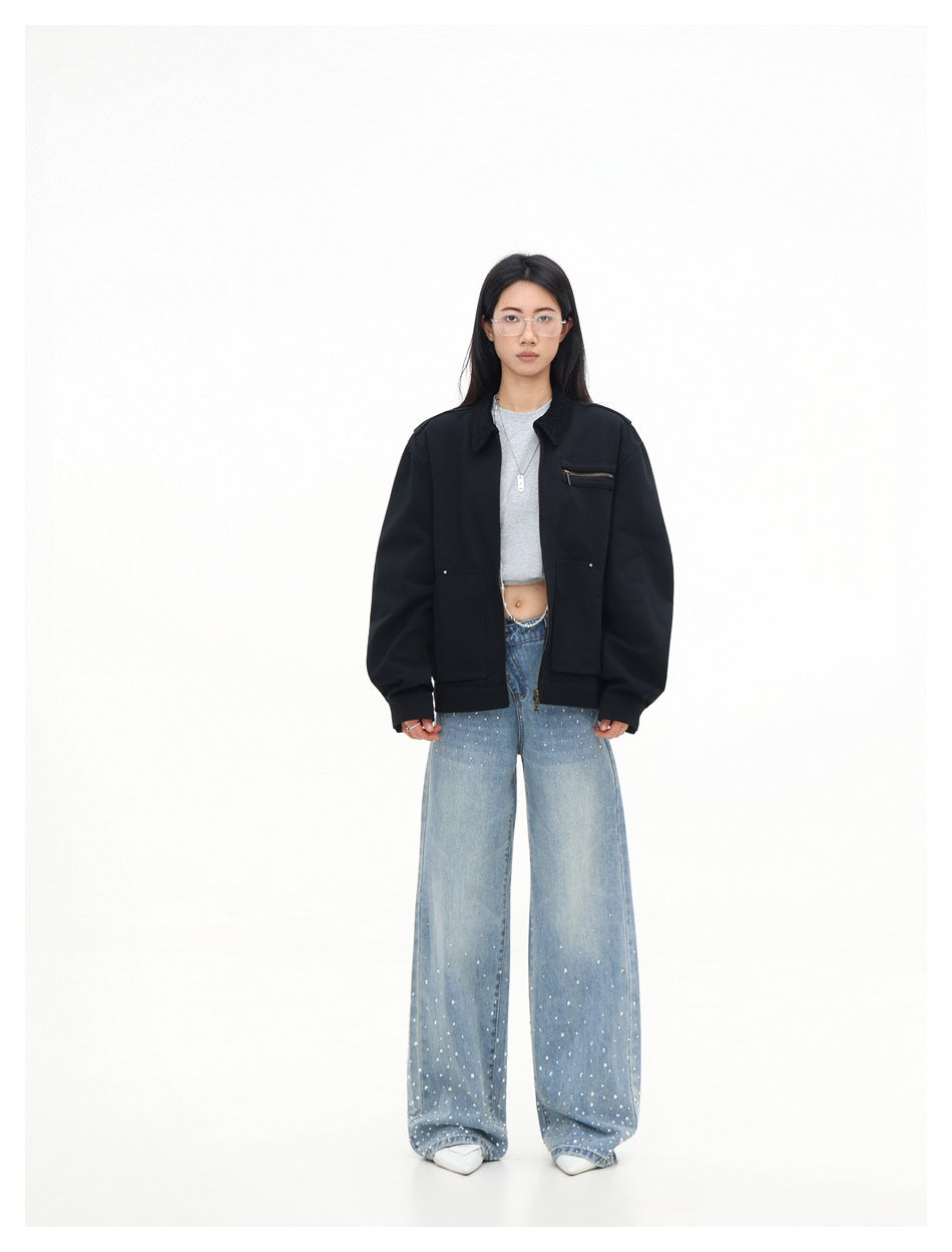 Model wearing a black zip jacket over a gray cropped top and light-wash wide-leg jeans, full-length front view