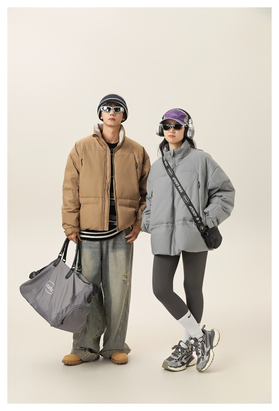 Two models wear puffer jackets: one tan with a high collar, the other light gray; both have zip fronts and roomy pockets.