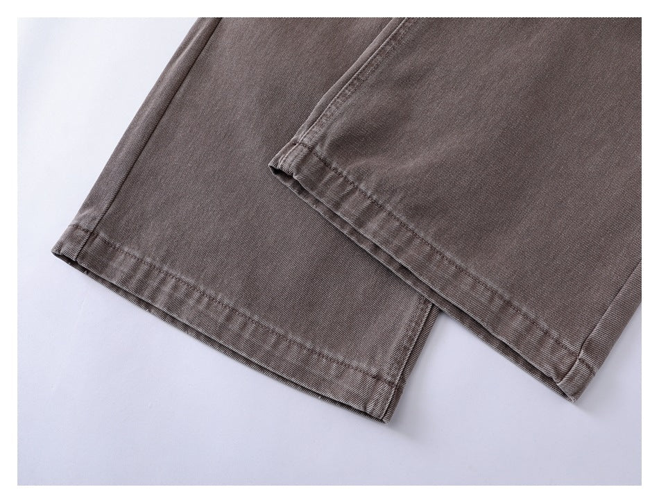 Close-up of the taupe wide-leg jeans’ stitched hems and fabric texture.