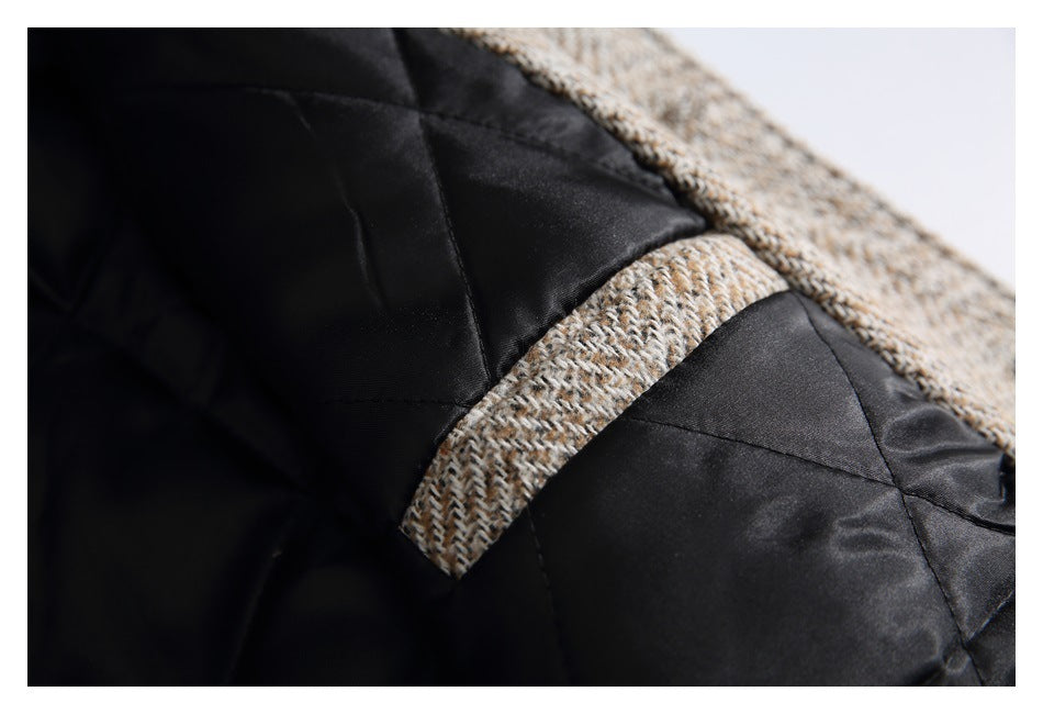 Close-up of the black quilted lining and herringbone shell at a garment seam.