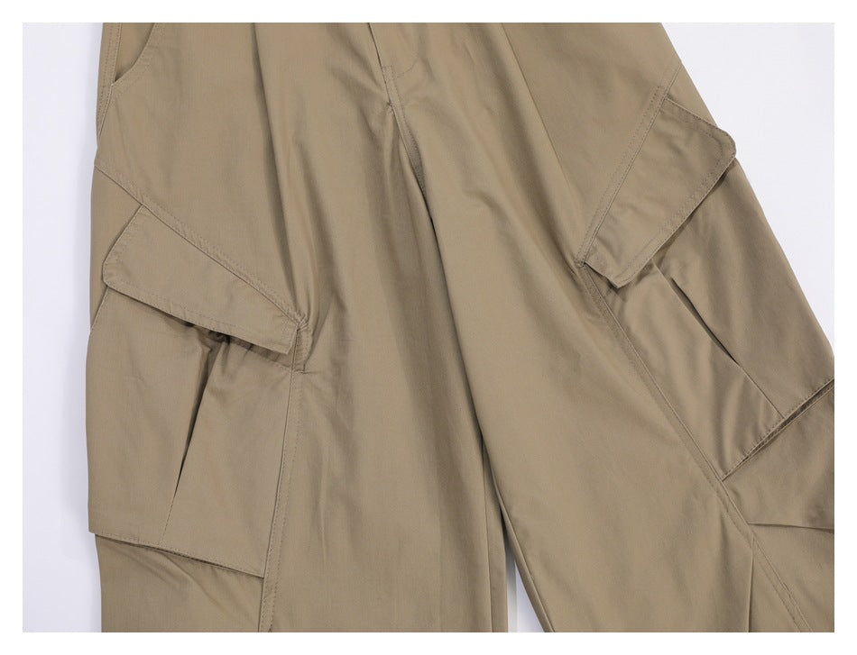 Close-up of khaki trousers with large flap cargo pockets and visible stitching.