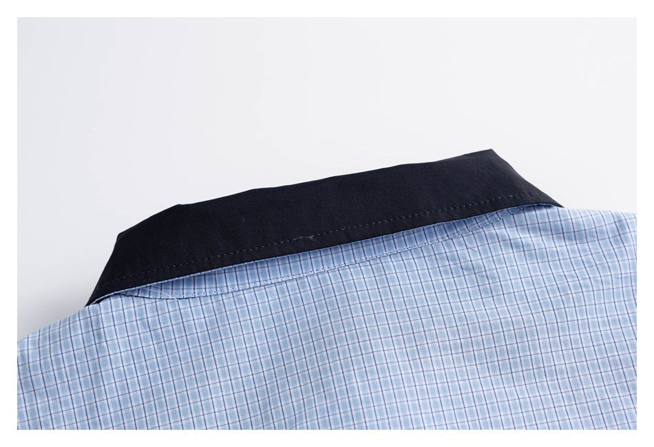 Close-up of the black back collar against light blue plaid fabric.