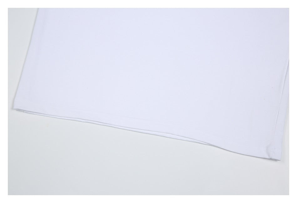 Close-up of the plain white T-shirt’s lower hem and stitching.