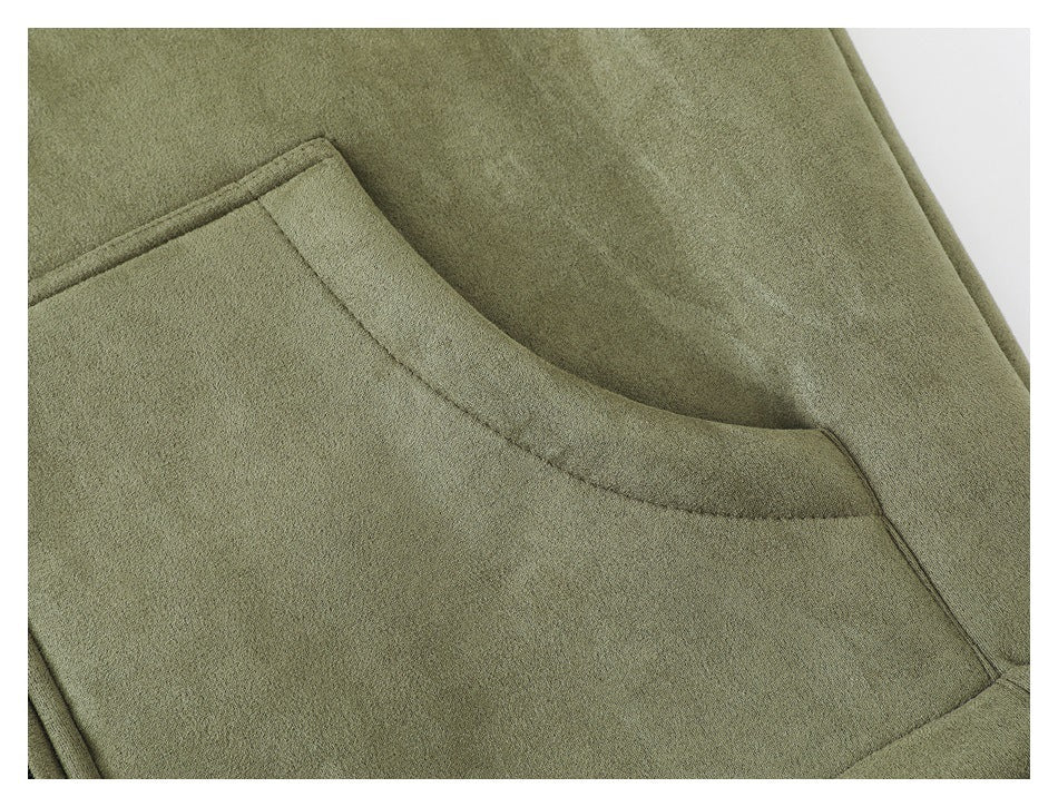 Close-up of a lower slanted pocket on the olive vest.