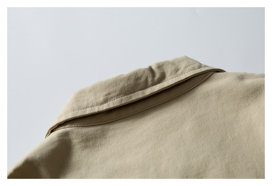 Close-up of the wide collar and upper back of a beige jacket.