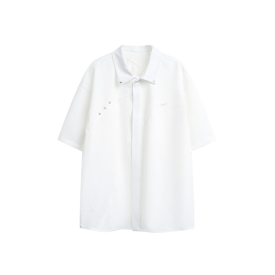White short-sleeve collared shirt flat lay with curved seams, star studs on the collar and shoulder, and tonal embroidery