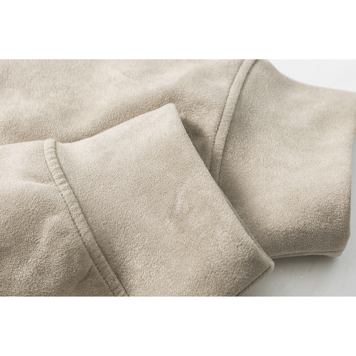 Close-up of the taupe sweatshirt’s soft fabric and folded sleeve cuff.