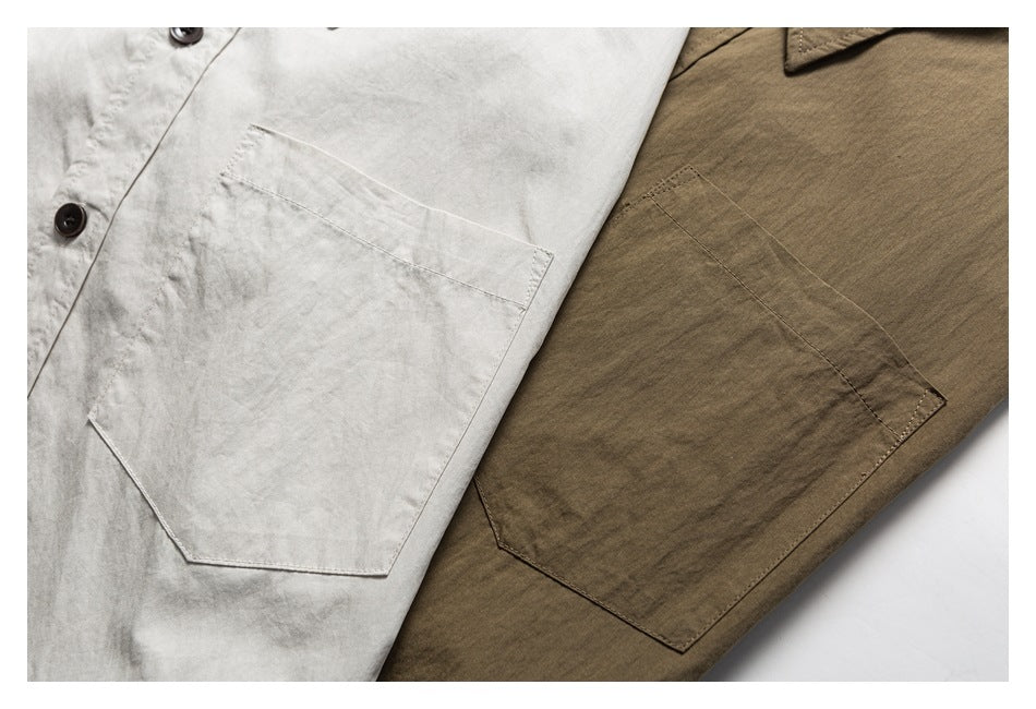 Close-up of overlapping off-white and brown garments, showing buttons and large stitched patch pockets.