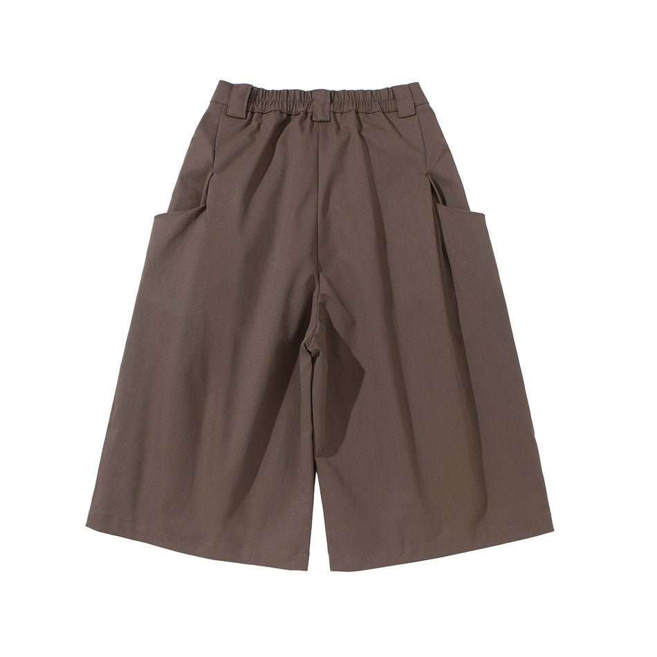 Front flat lay of taupe-brown wide-leg shorts with pleats, an elasticated waistband, belt loops and large side pockets.