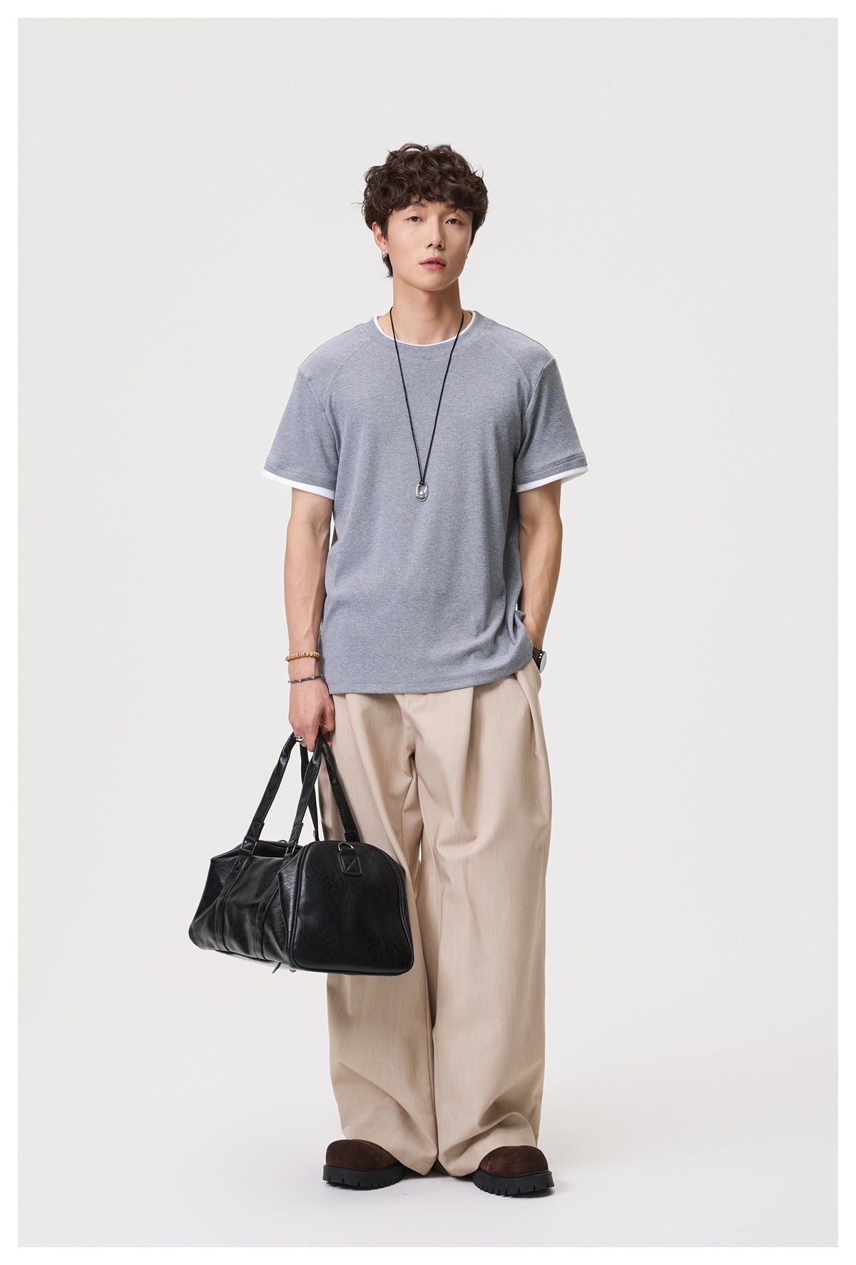 Model wearing a heather gray crew-neck T-shirt with white trim at the collar and sleeve cuffs.