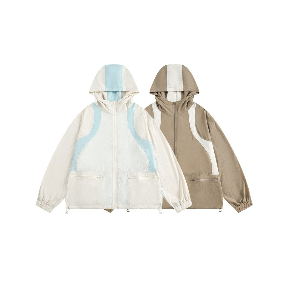 Two hooded color-block jackets shown from the front: ivory with pale blue panels and taupe with ivory panels.