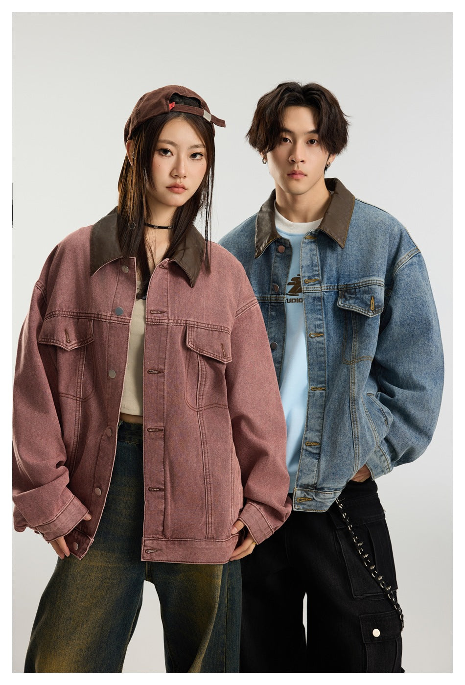 Two models pose in oversized dusty rose and blue denim jackets, both featuring contrasting dark collars.