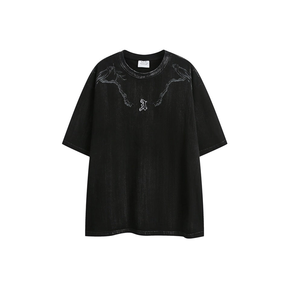 Black short-sleeve crew-neck T-shirt with distressed finish, bird-and-branch graphic and small gothic A emblem