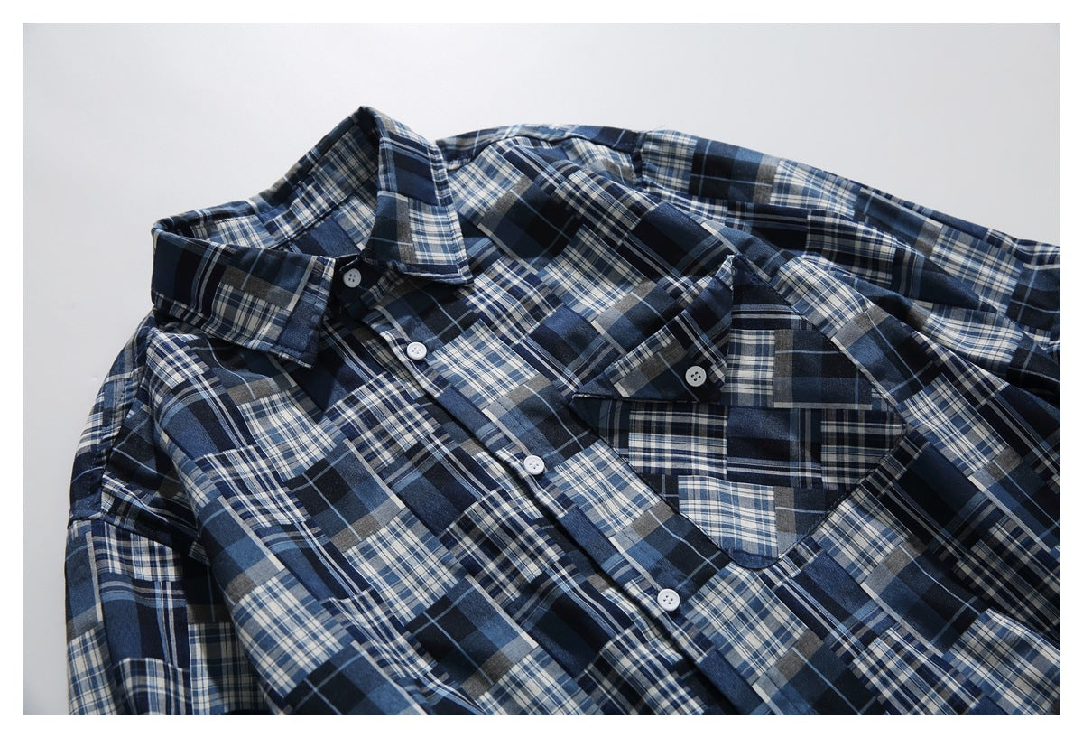 Angled close view of the plaid shirt's front, showing its pointed collar, white buttons, and chest pocket.
