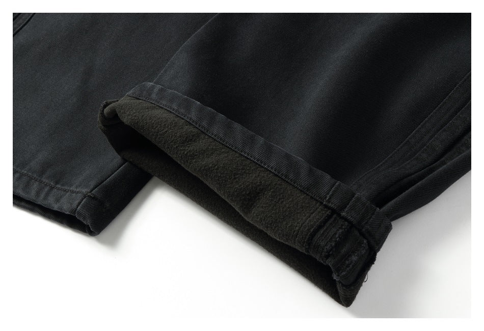 Black trouser cuff turned back to show a dark, soft-looking inner surface.