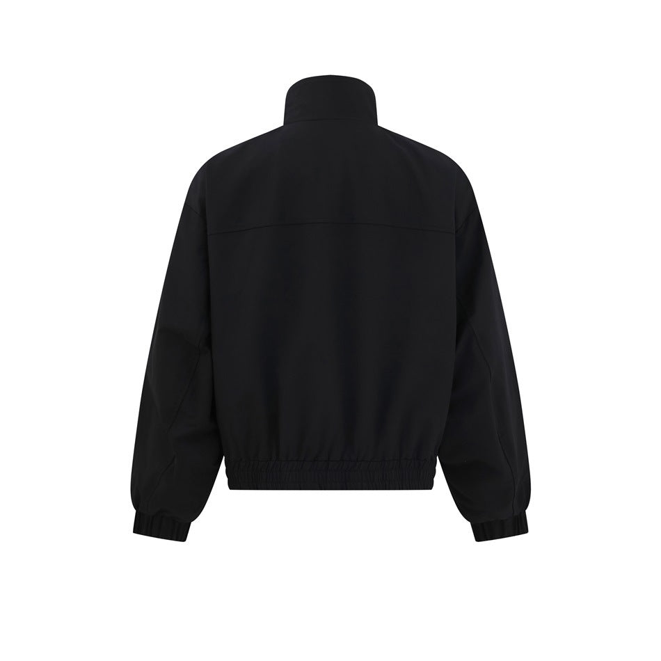 Back view of a black jacket with a high collar, shoulder yoke, and elasticated hem and cuffs.