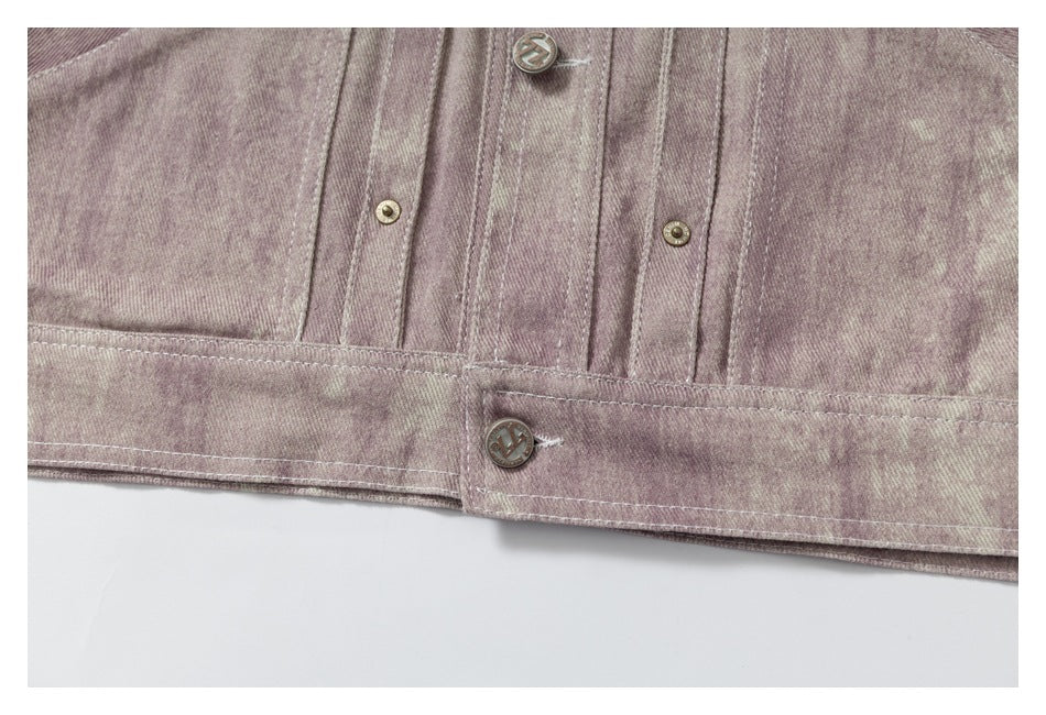 Close-up of the mauve mottled jacket's buttoned lower band and stitched front panels.
