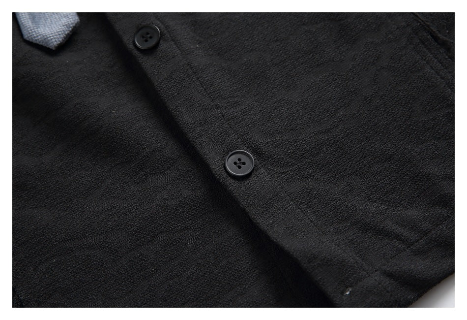 Close-up of black buttons and subtle woven pattern on the shirt front.