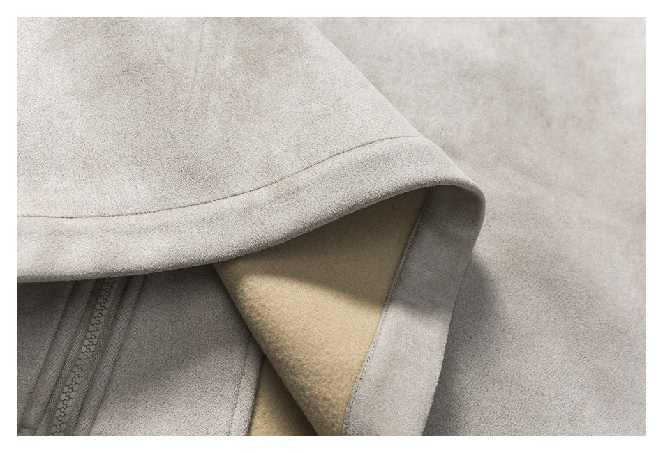 Close-up of the taupe jacket's folded hood or collar, zipper, and tan lining.