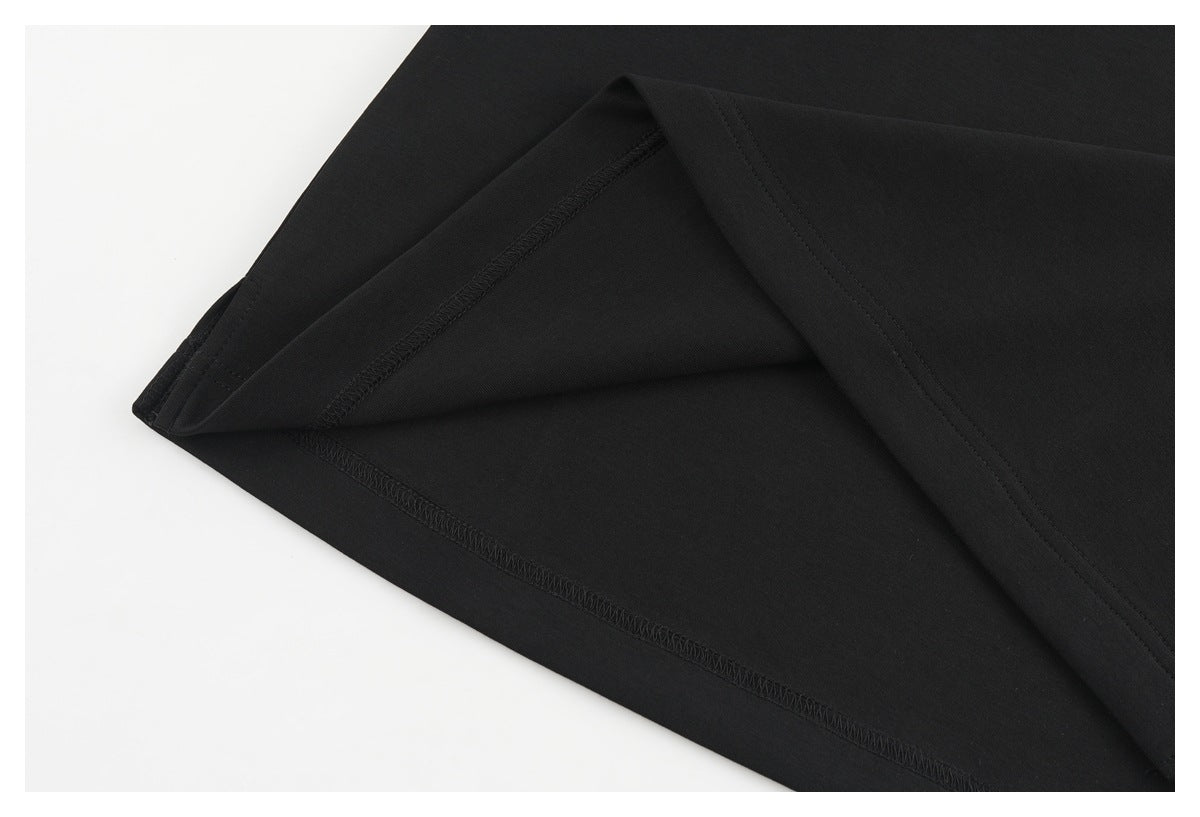 Close-up of a black shirt's turned-back hem, showing the inner overlock stitching.