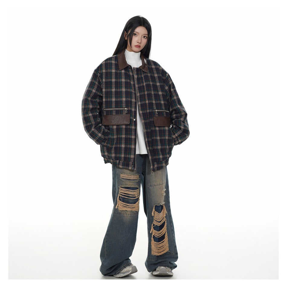 Full-length view of a model wearing the navy plaid jacket with hands in pockets, white top and wide ripped jeans