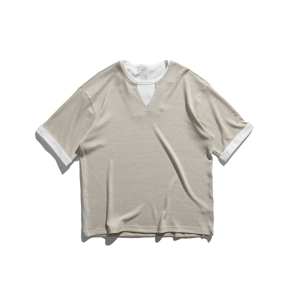 Apricot waffle-textured short-sleeve tee with white inner collar layer, V notch and white rolled cuffs, flat lay
