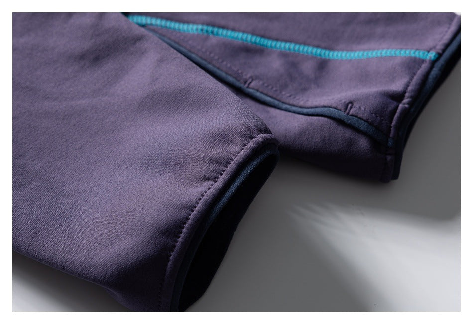 Close-up of a dark purple garment hem and teal seam stitching.