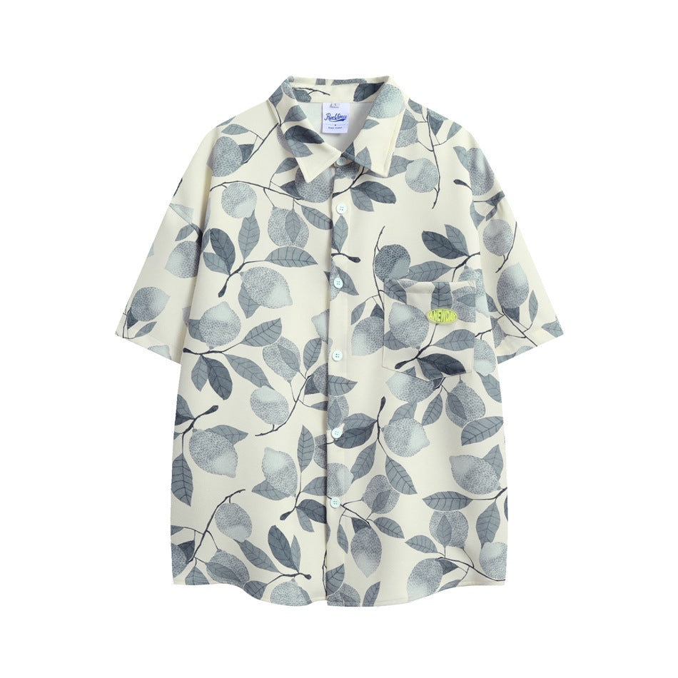 Cream short-sleeve button-up shirt with a gray-blue lemon and leaf print and a chest pocket with a small logo patch