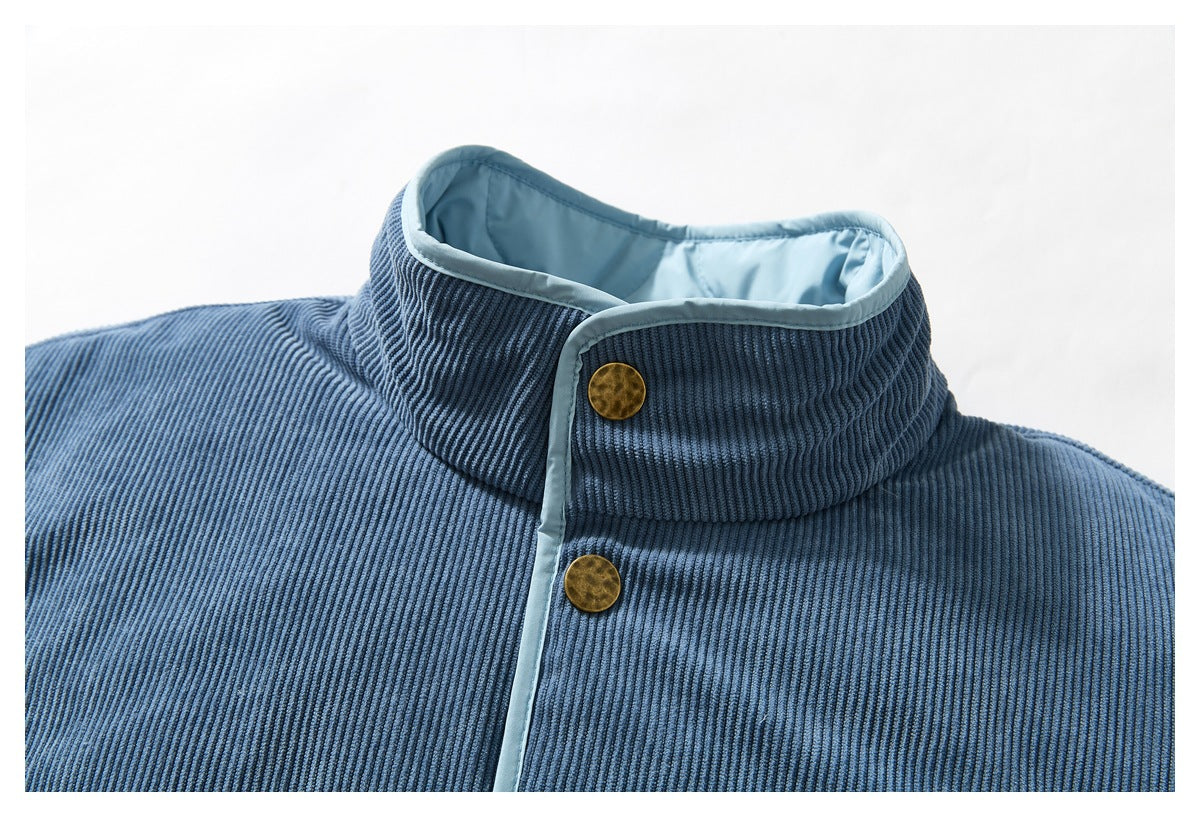 Close-up of a blue ribbed jacket collar with pale blue lining and brass-colored snaps.