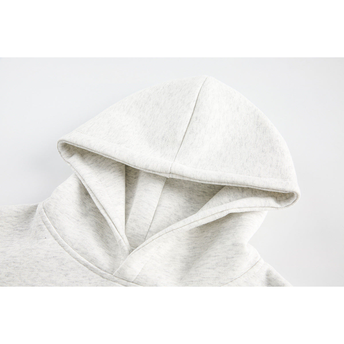 Close-up of the light heather gray hood and neckline of a pullover hoodie.