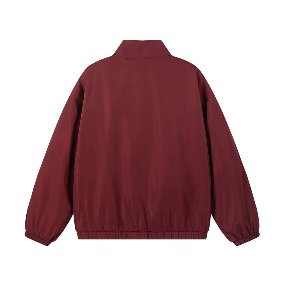 Back view of a burgundy jacket with a raised collar and elasticated cuffs and hem.