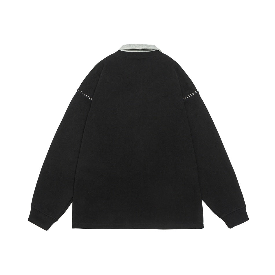 Back view of a black long-sleeve top with a light gray collar and short white stitch accents on the upper sleeves.