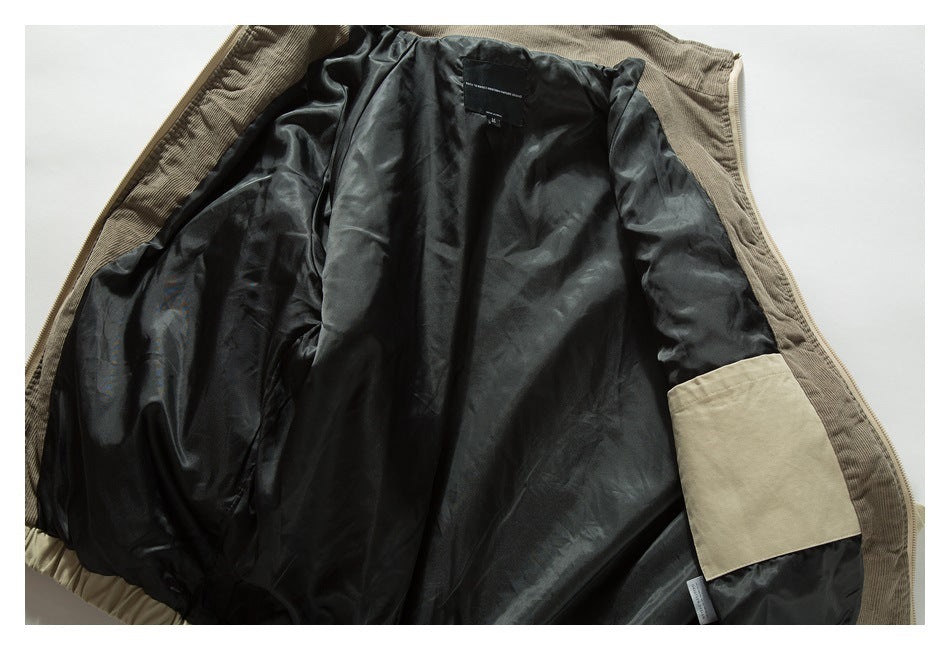 Open tan jacket laid flat, showing its black lining and inner pocket.