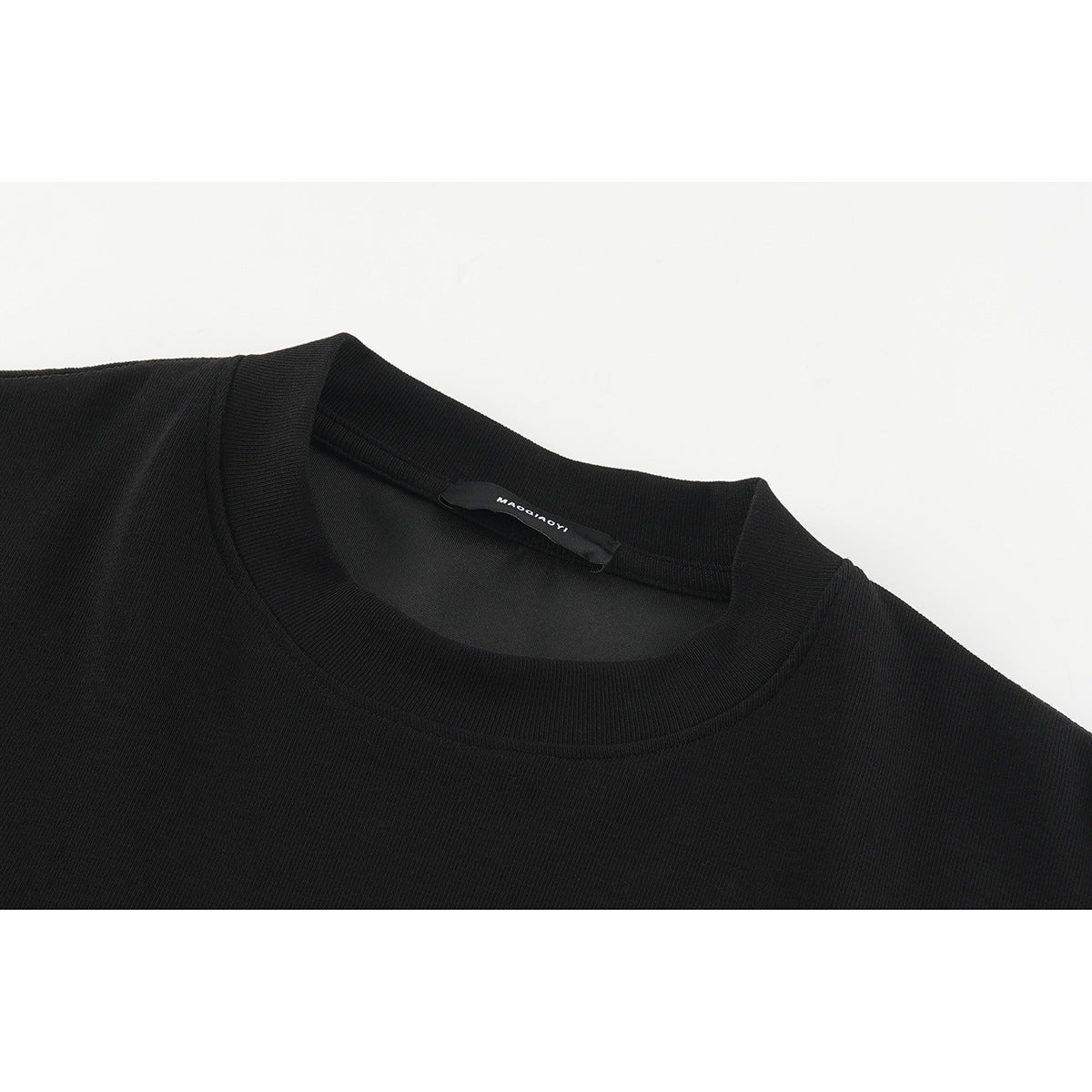 Close-up of a black crew neck and ribbed collar with an inner neck label.